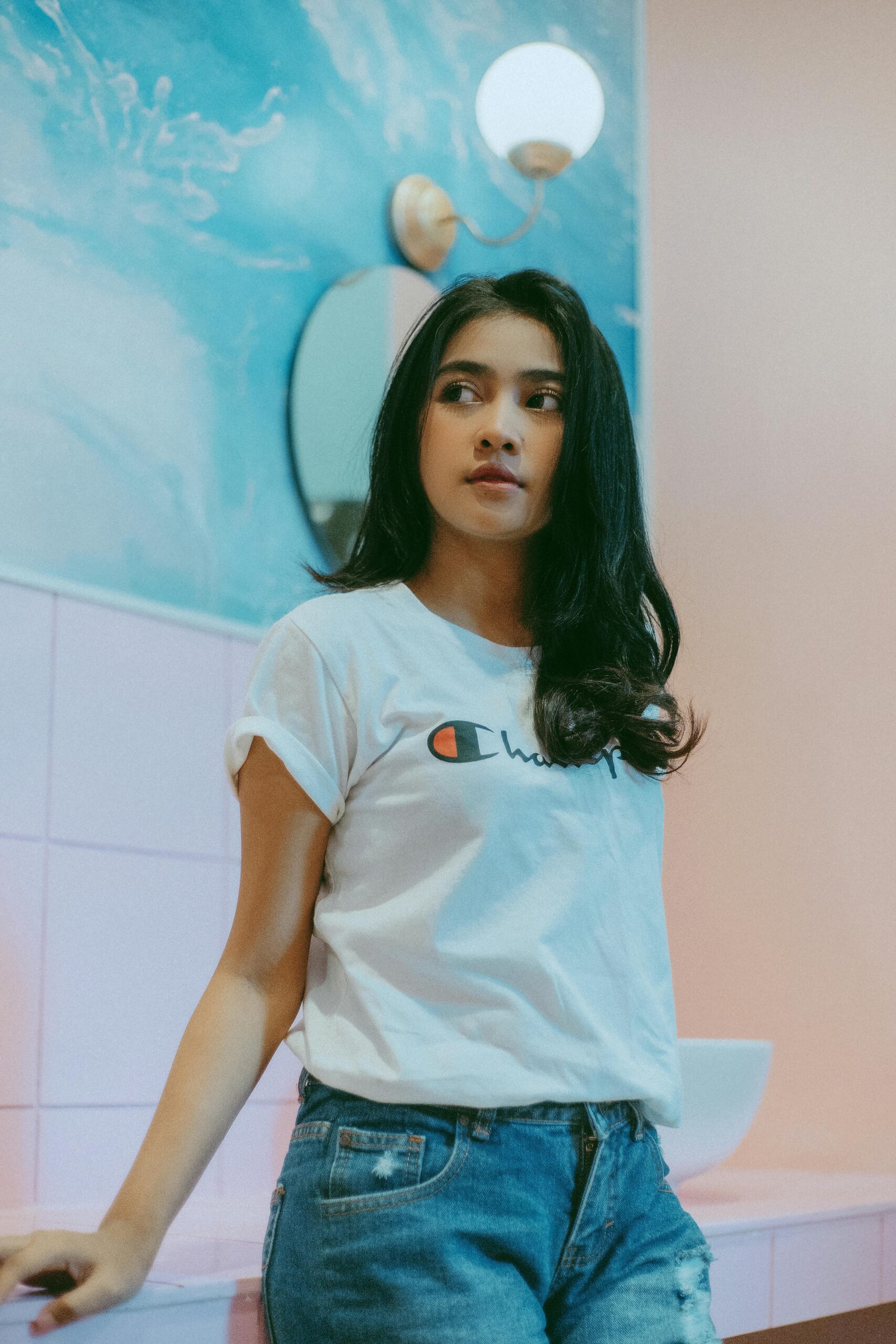 Girl in White T-shirt Standing Near Blue Wall